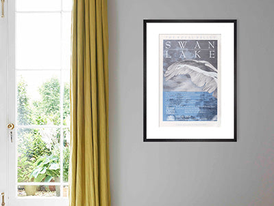 Framed Swan Lake Print on a wall next to window